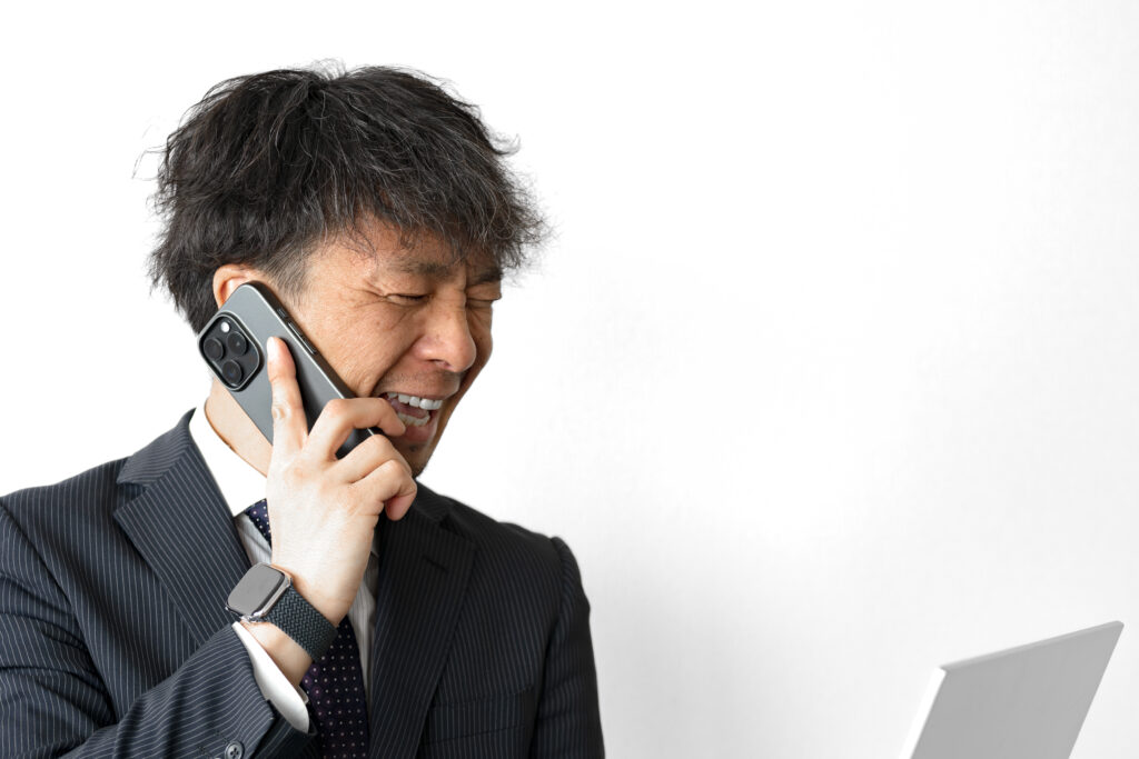 苦しそうな表情のビジネスマン