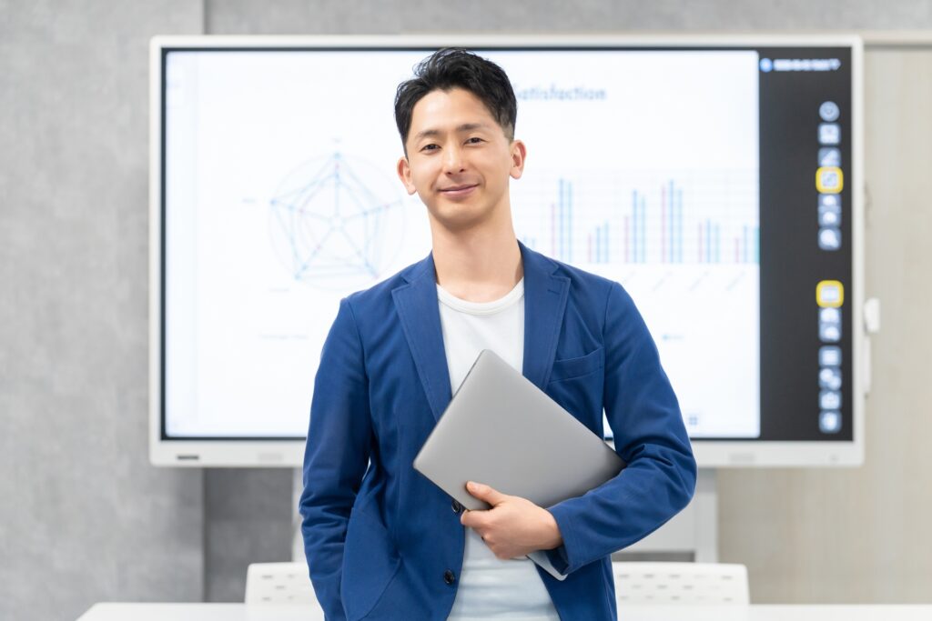 ノートパソコンを持つ笑顔のビジネスマン