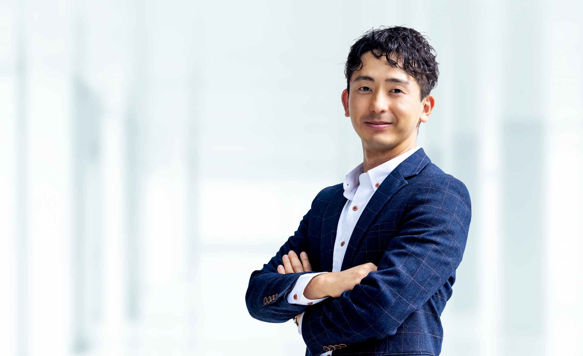 腕組みをする笑顔の男性ビジネスマン