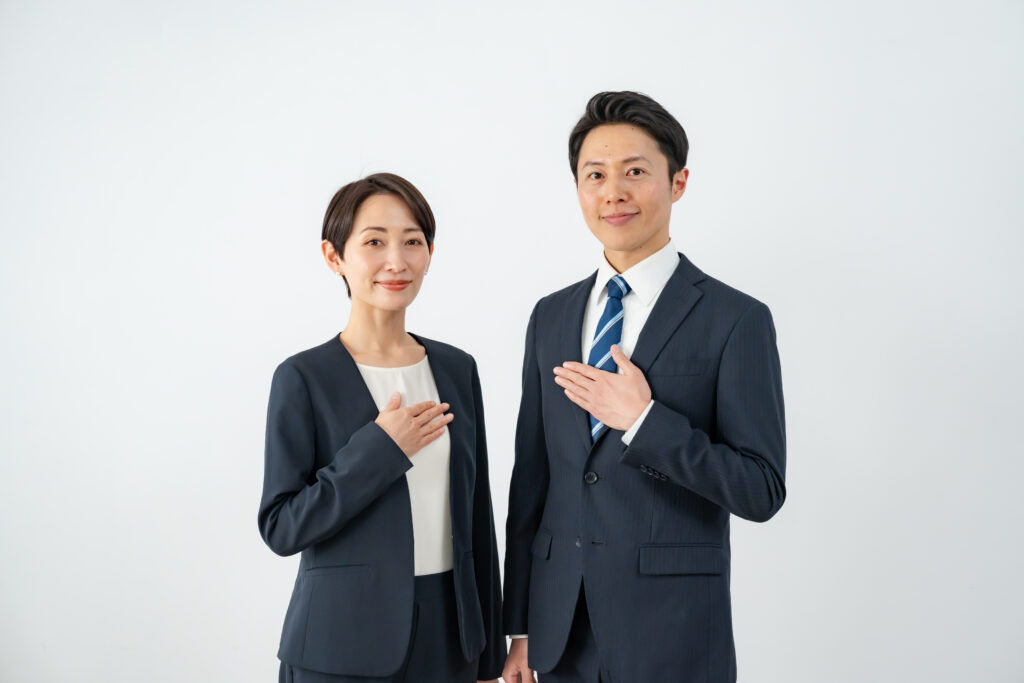 胸に手を当てるビジネスマン