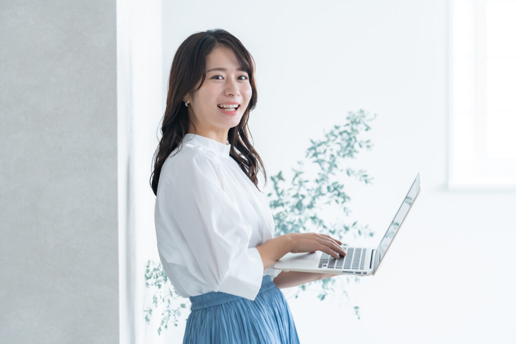 ノートパソコンを持つ若い女性