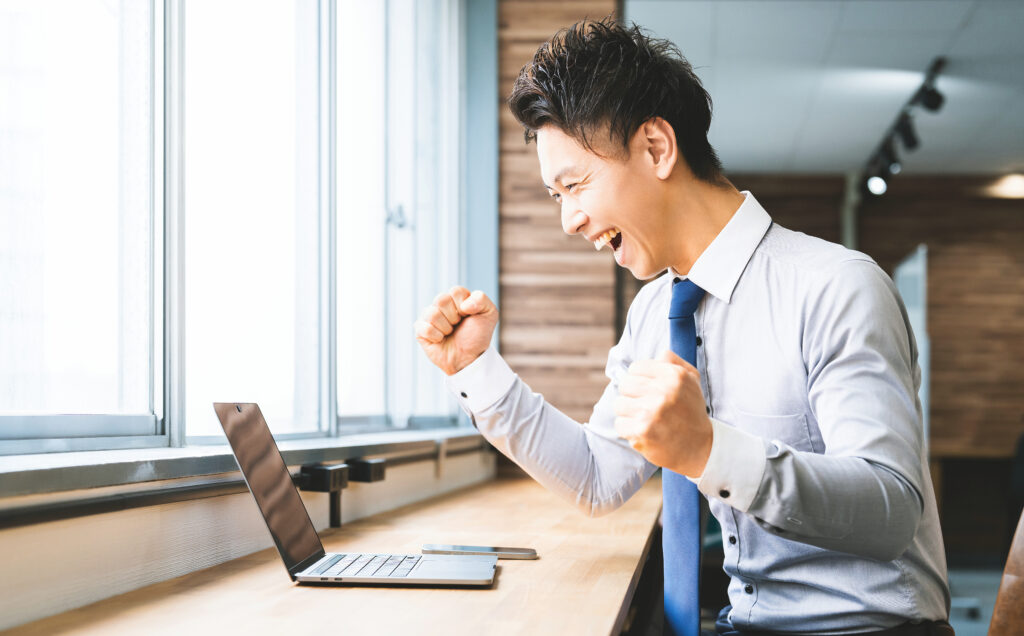 ガッツポーズをする笑顔の男性ビジネスマン