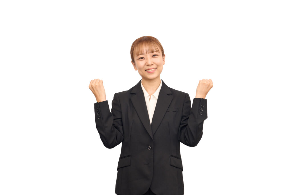 ビジネススーツを着た女性のガッツポーズ