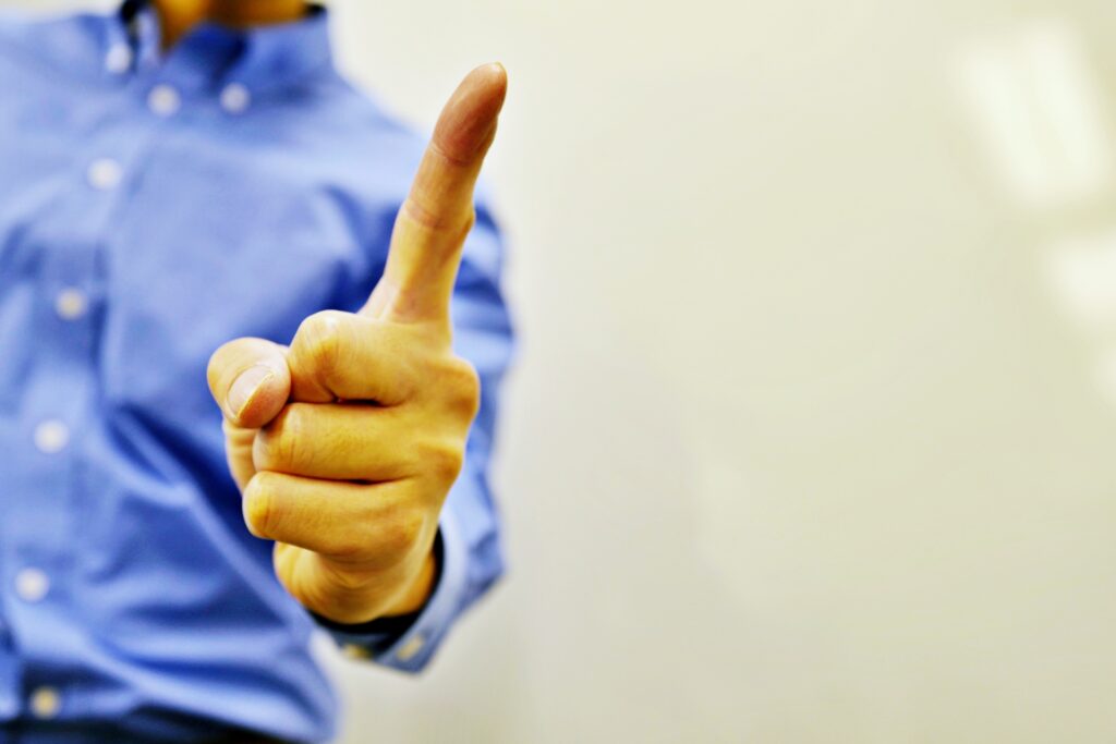 人差し指で注意する男性