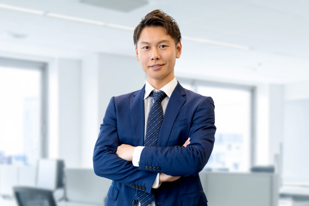 腕組みをする笑顔の男性ビジネスマン