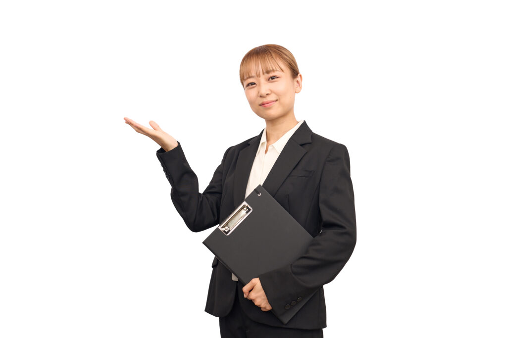 どうぞのポーズをビジネススーツを着た女性